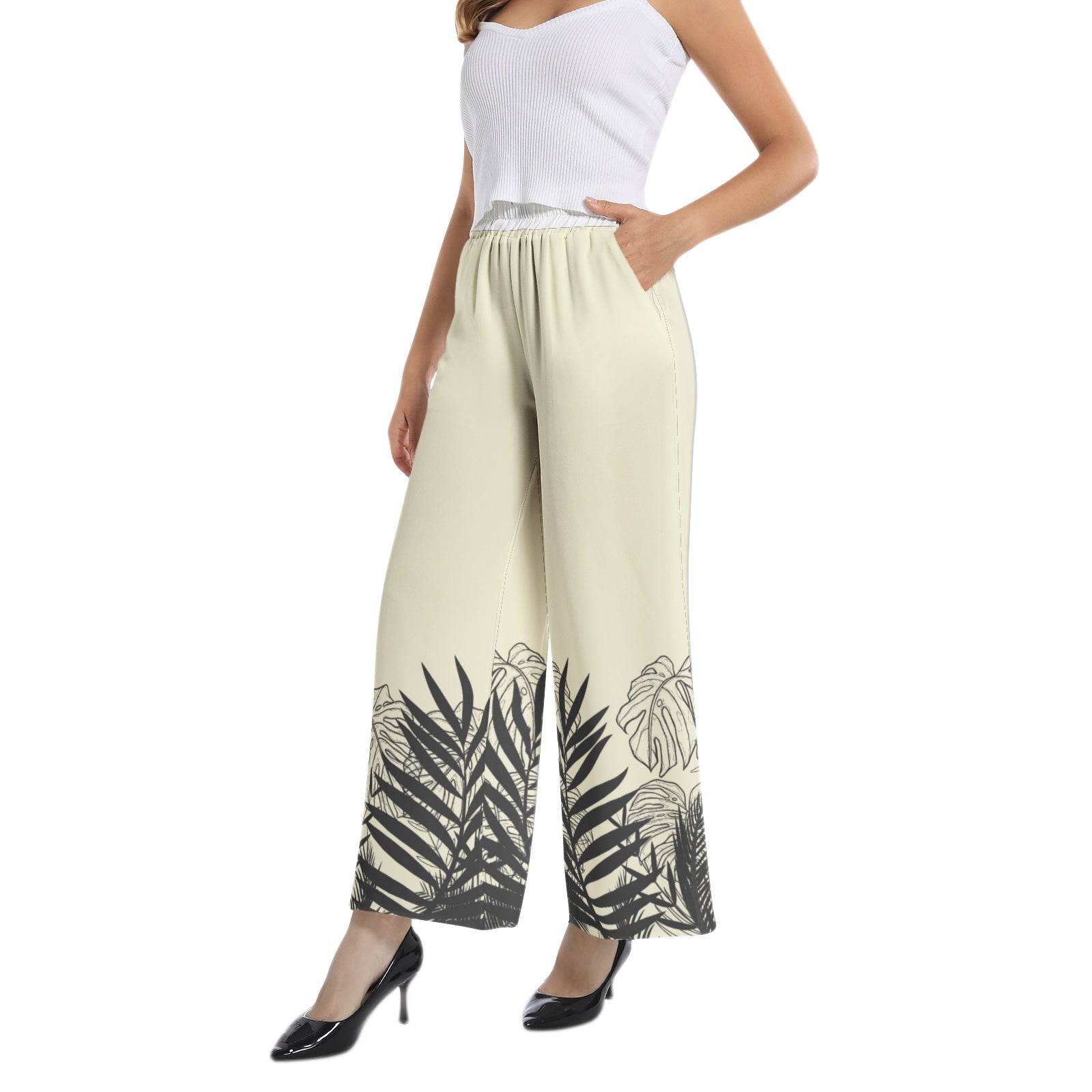 Experience effortless style with our Women's Beige Designer Pant and Matching Top. The graphic print of black tropical leaves adds a touch of elegance to the wide leg silhouette. The elastic waistband ensures a comfortable and flattering fit, perfect for any occasion. Upgrade your wardrobe with this must-have set.