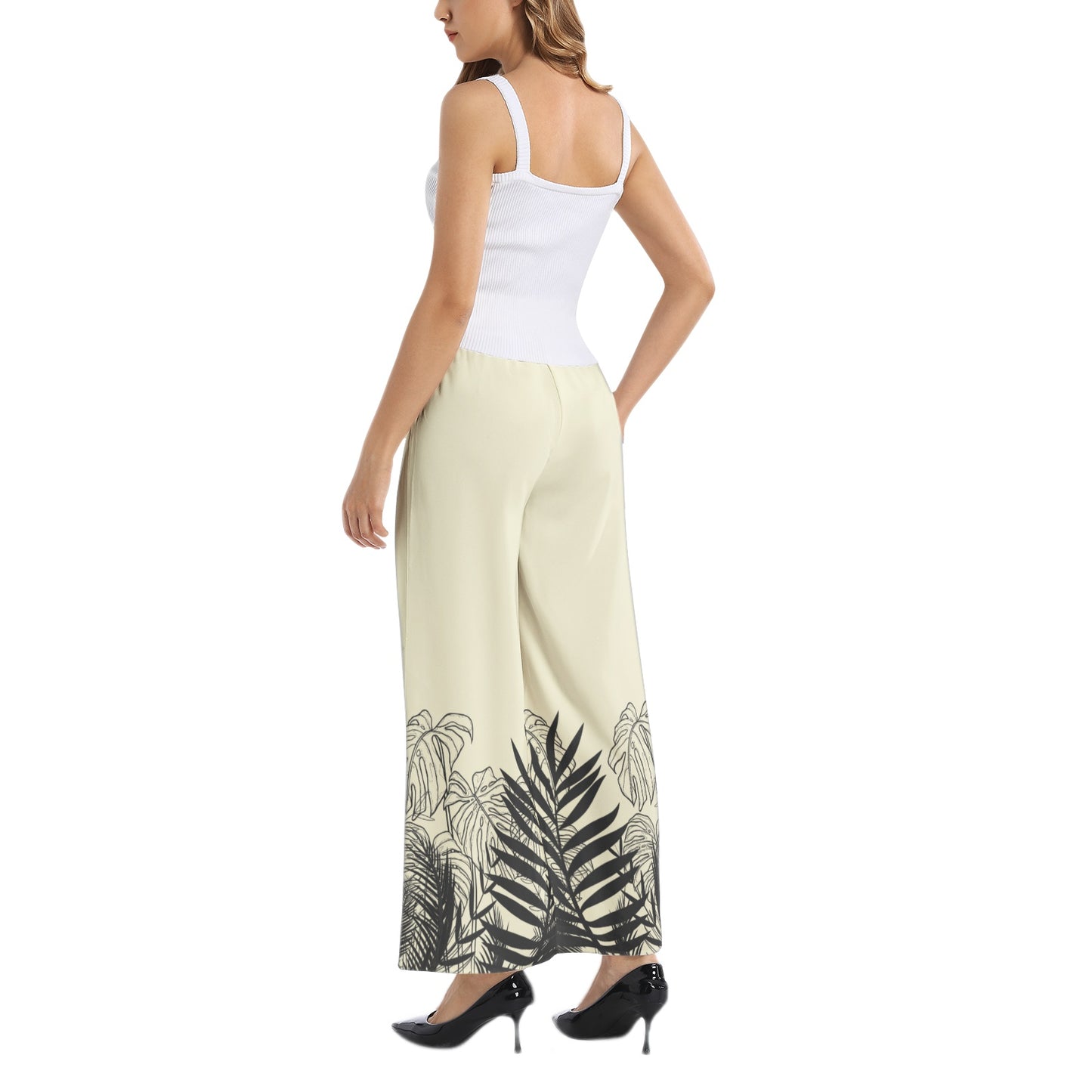 Experience effortless style with our Women's Beige Designer Pant and Matching Top. The graphic print of black tropical leaves adds a touch of elegance to the wide leg silhouette. The elastic waistband ensures a comfortable and flattering fit, perfect for any occasion. Upgrade your wardrobe with this must-have set.