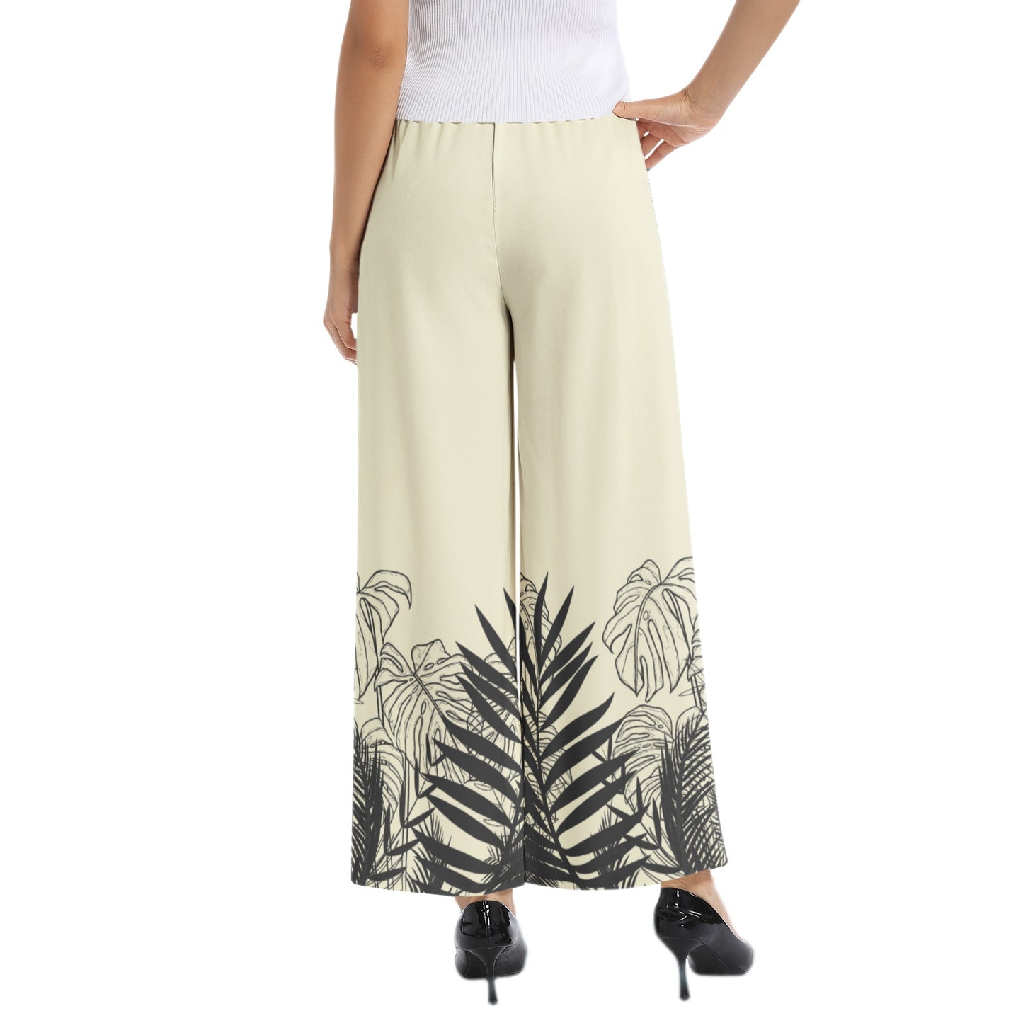 Experience effortless style with our Women's Beige Designer Pant and Matching Top. The graphic print of black tropical leaves adds a touch of elegance to the wide leg silhouette. The elastic waistband ensures a comfortable and flattering fit, perfect for any occasion. Upgrade your wardrobe with this must-have set.