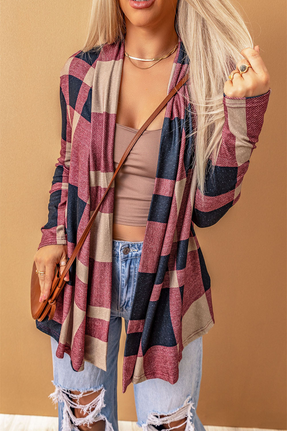 Unleash your inner fashionista with our Draped Open Front Plaid Cardigan. This versatile piece adds a touch of casual chic to any outfit. The draped design creates a relaxed look, while the open front allows for easy styling with a t-shirt, jeans, and sneakers. Made with soft and lightweight fabric for a cozy feel. Unleash your style and comfort with this must-have cardigan.