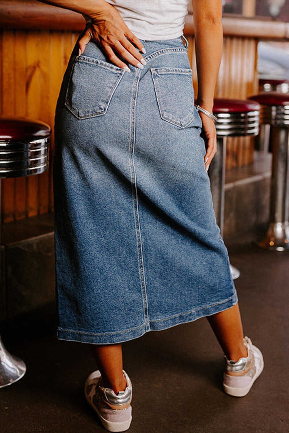 Elevate your wardrobe with our Classic Sky Blue Midi Denim Skirt! This stylish piece features a front slit and convenient pockets, adding a modern touch to the classic denim design. Perfect for any occasion, feel confident and fashionable in this must-have piece!