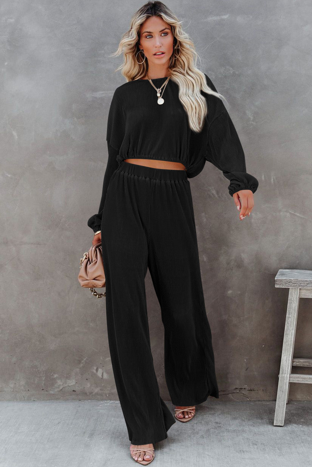 Elevate your fall wardrobe with our Black Cropped Pullover Sweater &amp; Wide Leg Pants Set. The cropped sweater adds a modern twist while the wide leg pants provide both comfort and style. Perfect for any occasion, this set will keep you looking effortlessly chic.