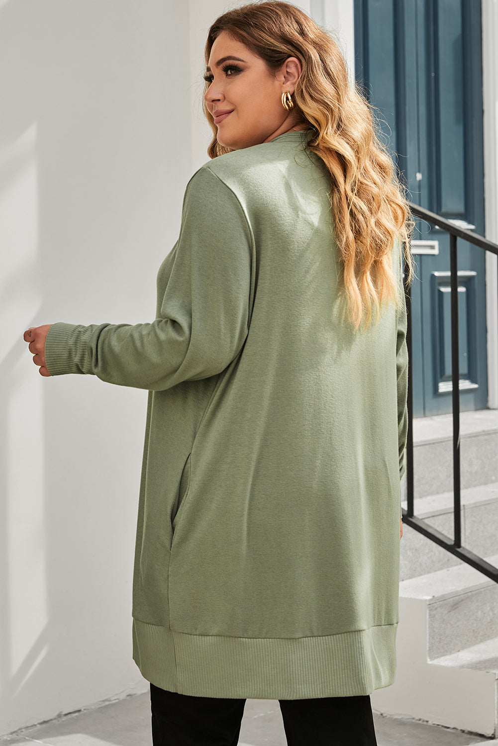 A versatile and dainty addition to any wardrobe, this green plus-size cardigan features a snap-button closure and ribbed trim for a vintage feel. With convenient pockets, it's perfect for adding a touch of warmth while running errands or lounging at home. Pair with a long-sleeve top and skinny pants for a complete casual look. (Fits ladies of all sizes!)