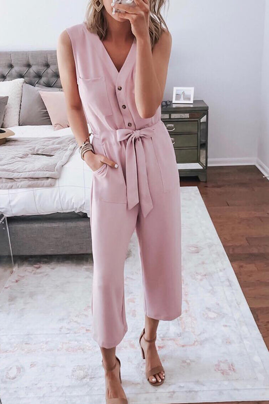 Elevate your style game with our Pink Buttoned Sleeveless Cropped Jumpsuit! The elegant sash, combined with the flattering cropped length, creates a chic look that will turn heads. Designed to keep you comfortable and stylish, this jumpsuit is perfect for any occasion. Add it to your wardrobe today!