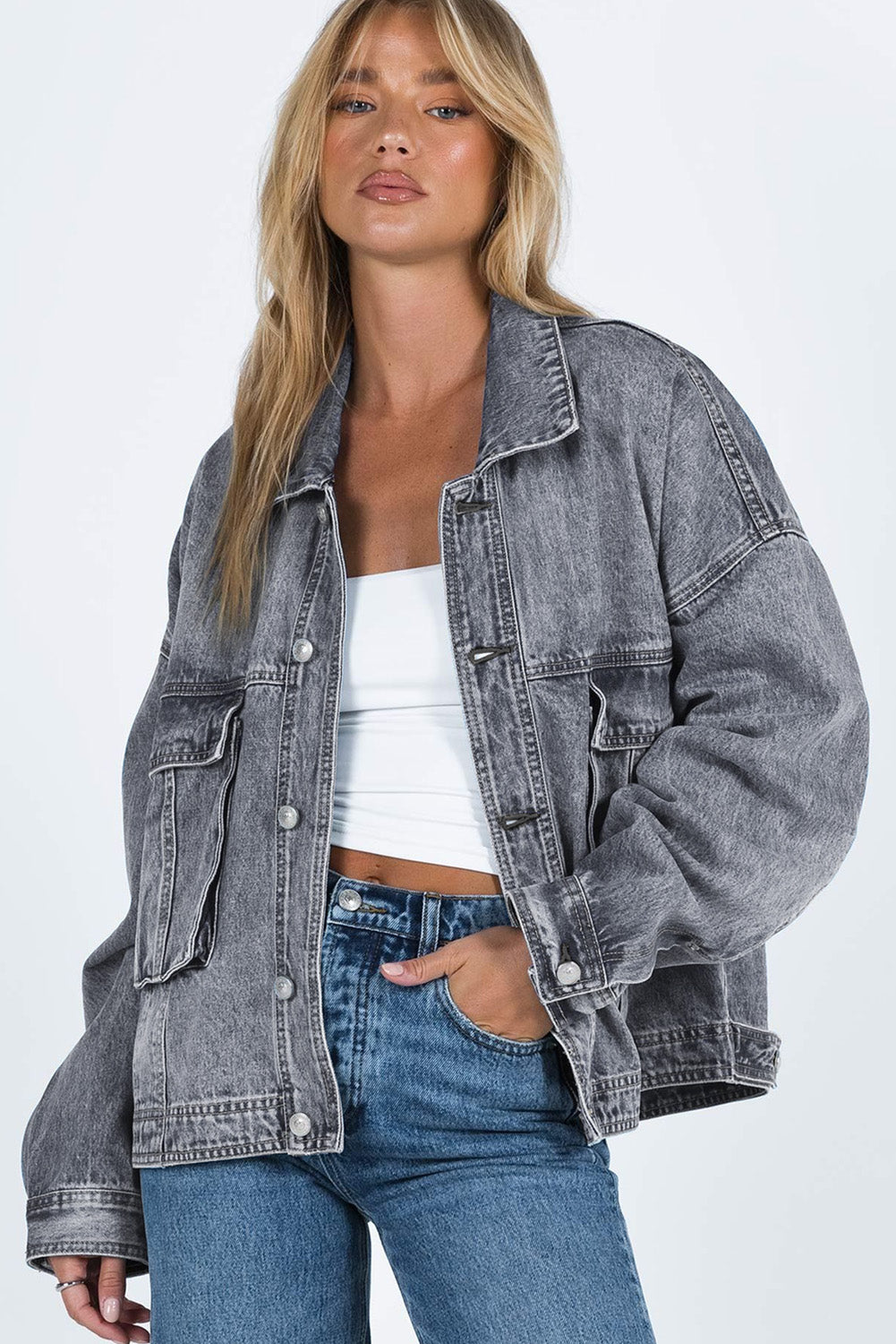 Get ready to rock any look with our Gray Chest Pockets Drop Shoulder Loose Denim Jacket. The ultimate layering piece, its versatile fit is perfect for all body types. The metal buttons add a touch of cool and durability, while the drop shoulder design gives off an effortless vibe. Plus, the chest pockets add both practicality and style.