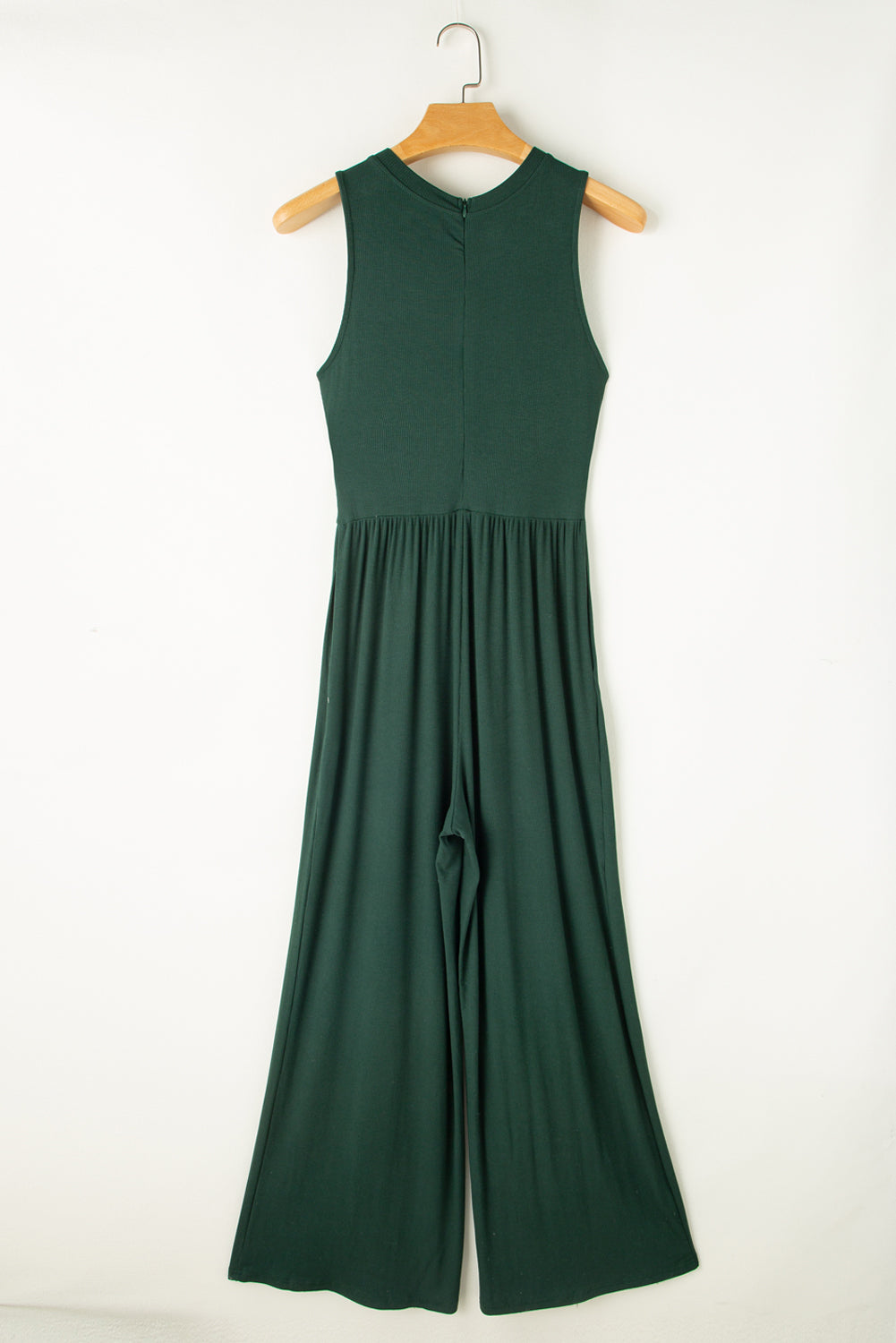 Made from high-quality fabric, this jumpsuit exudes luxury with its deep green hue, adding a touch of richness and depth to your ensemble. The sleeveless design and wide-leg silhouette create a flattering and elongating effect, while offering freedom of movement and comfort.