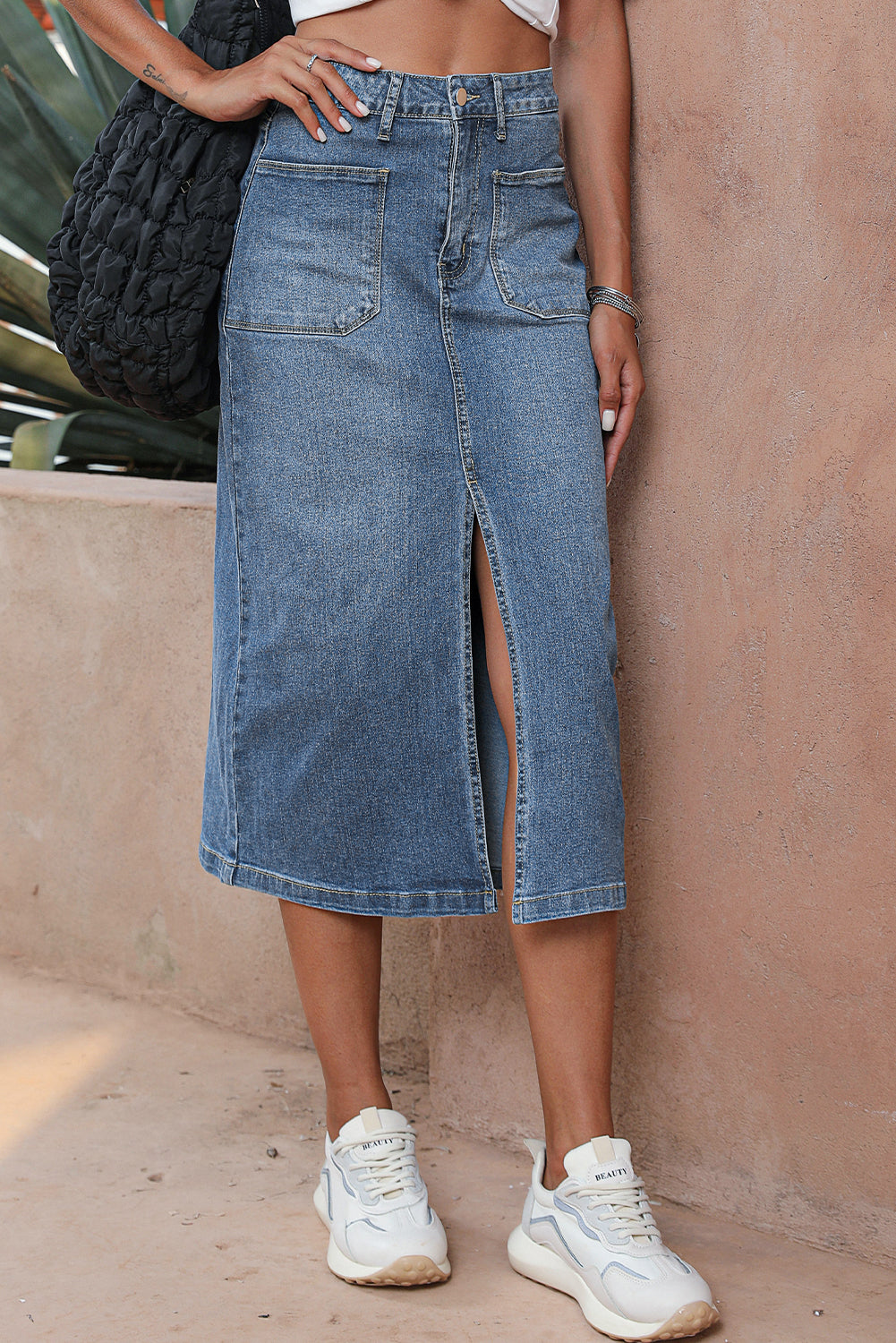 Elevate your wardrobe with our Classic Sky Blue Midi Denim Skirt! This stylish piece features a front slit and convenient pockets, adding a modern touch to the classic denim design. Perfect for any occasion, feel confident and fashionable in this must-have piece!