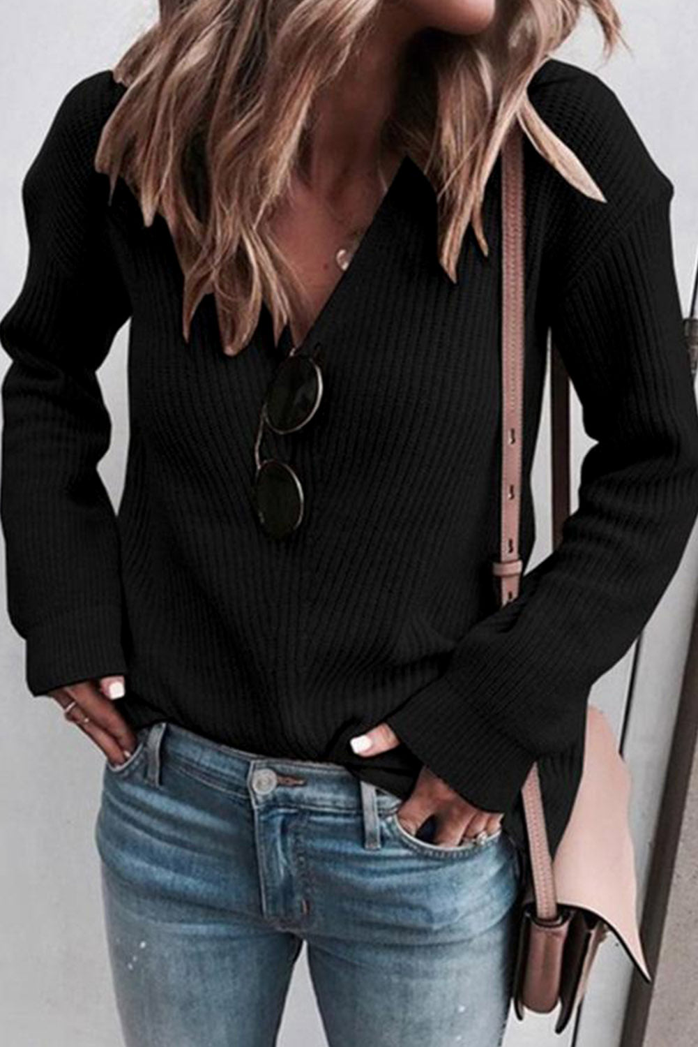 Cozy up in style with our Black Ribbed Knit V Neck Sweater. Made with a soft and stretchy ribbed knit fabric, this sweater features a flattering v neck design. Perfect for pairing with jeans or leggings, it's a versatile and stylish addition to any wardrobe.