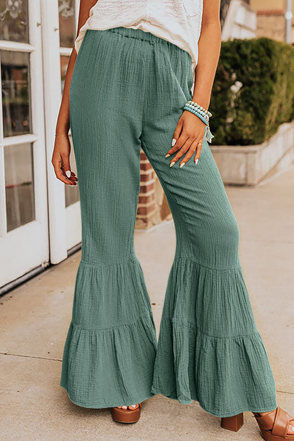 Elevate your style with our Classy Green Textured High Waist Ruffled Bell Bottom Pants! A perfect blend of elegance and comfort, these pants feature a high waist for a flattering fit, ruffled details for a touch of femininity, and bell bottom design for added flair. Look effortlessly chic and feel confident in these pants.