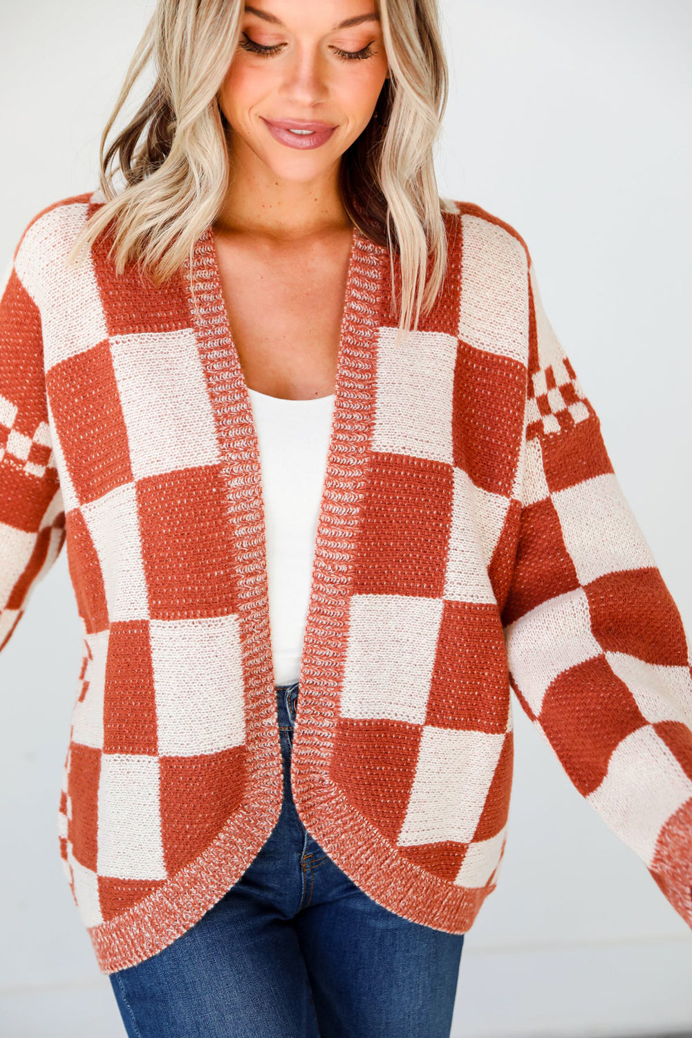 Introducing our Chestnut Mix Checkered Cardigan, a chic and classic addition to any wardrobe. Its checkered pattern is sure to make you fall in love with this knit coat. The open front design makes it easy to layer over any outfit, perfect for pairing with jeans, skirts, or dresses.