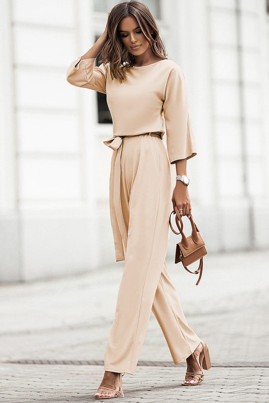Experience effortless style with our Apricot Bracelet Sleeve Waist Tie Wide Leg Jumpsuit. The bracelet sleeves and waist tie accentuate your figure while the wide legs provide comfort and functionality. Perfect for any occasion, this jumpsuit will elevate your wardrobe and showcase your unique style.