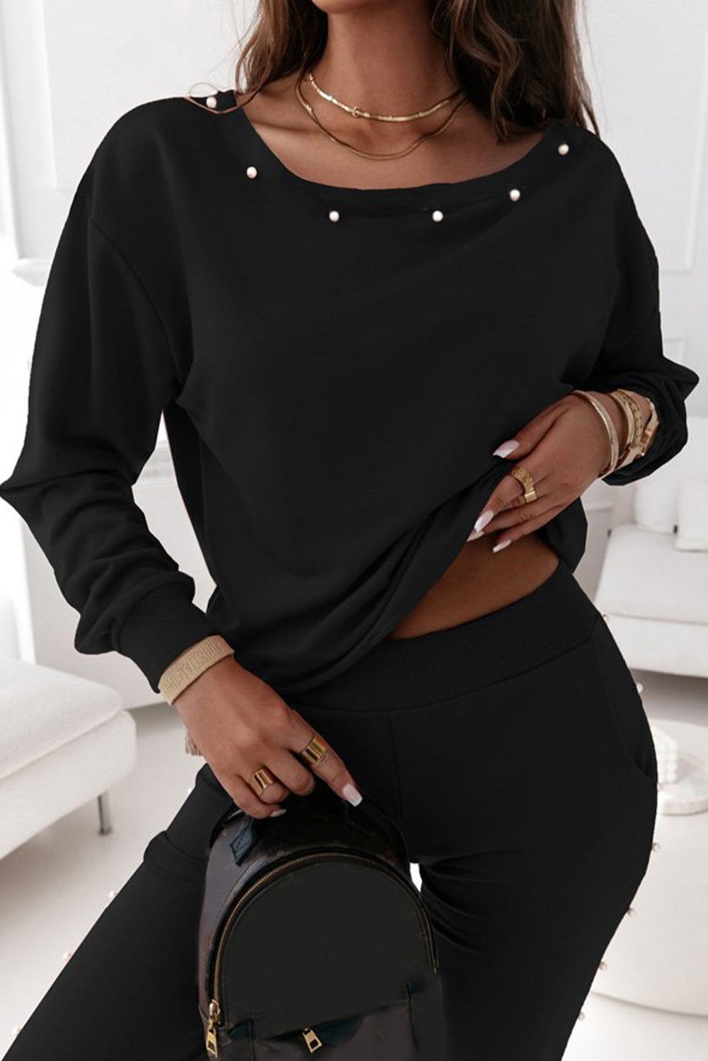 Elevate your loungewear game with our Black Beaded Decor Pullover and Jogger Pants Set. The intricate beaded design adds a touch of glam while the soft and comfortable fabric ensures maximum coziness. Stay stylish and comfortable in this must-have set.